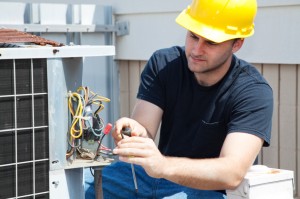 Electrician working on air conditioner