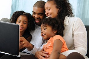 family looking at computer together