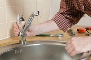 Plumber installing faucet 